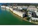 Aerial view of waterfront condo complex with lush greenery, and convenient parking at 6025 Shore S Blvd # 611, Gulfport, FL 33707