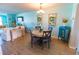 Dining area with a round table and chairs, wood floors, and decorative wall hangings at 6025 Shore S Blvd # 611, Gulfport, FL 33707
