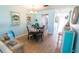 Dining area with a round table and chairs, wood floors, and decorative wall hangings at 6025 Shore S Blvd # 611, Gulfport, FL 33707
