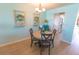 Dining area with a round table and chairs, wood floors, and decorative wall hangings at 6025 Shore S Blvd # 611, Gulfport, FL 33707