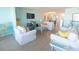Airy living room featuring coastal decor, comfortable seating, and an open floor plan at 6025 Shore S Blvd # 611, Gulfport, FL 33707