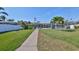 A large lawn leads to a covered boat dock, providing quick access to waterways at 6324 Balboa Ln, Apollo Beach, FL 33572