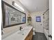 Modern bathroom features a sleek vanity, large mirror, and a combined tub and shower at 6324 Balboa Ln, Apollo Beach, FL 33572