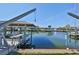 Dock with boat lift with metal supports and pulley systems at 6324 Balboa Ln, Apollo Beach, FL 33572