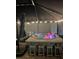 Nighttime shot of the hot tub with illuminated pink flamingo floats and stools, creating a relaxing spa environment at 6324 Balboa Ln, Apollo Beach, FL 33572