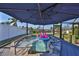 Inviting hot tub under shaded patio with canal views, perfect for relaxation and entertaining, with fun flamingo float at 6324 Balboa Ln, Apollo Beach, FL 33572