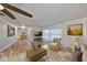 Open living room featuring wood flooring, large windows, and comfortable seating at 6324 Balboa Ln, Apollo Beach, FL 33572