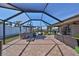 Wide view of the screened-in patio showing the canal-front backyard with covered seating at 6324 Balboa Ln, Apollo Beach, FL 33572