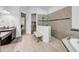 Bright bathroom features a soaking tub, walk-in shower, double vanity, and granite countertops at 7133 Hatpin Loop, Wesley Chapel, FL 33545