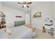 Bright bedroom has carpet, a window, neutral walls, playful decor and desk space at 7133 Hatpin Loop, Wesley Chapel, FL 33545