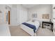 Comfortable bedroom with a white bed, a desk, and organized shelving for a clutter-free space at 7133 Hatpin Loop, Wesley Chapel, FL 33545