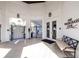 Exterior view of the clubhouse entrance, featuring a bench, gated entrance, and decorative sconces at 7133 Hatpin Loop, Wesley Chapel, FL 33545