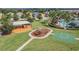 Aerial view of the community park, including a playground, basketball court, and picnic area at 7133 Hatpin Loop, Wesley Chapel, FL 33545