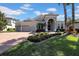 Beautiful one-story home featuring a three-car garage, archway entrance and lush landscaping at 7133 Hatpin Loop, Wesley Chapel, FL 33545