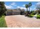 Stunning one-story home with a three-car garage, arched entrance and lush landscaping at 7133 Hatpin Loop, Wesley Chapel, FL 33545