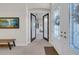 Foyer view with a decorative front door and access to a bonus room at 7133 Hatpin Loop, Wesley Chapel, FL 33545
