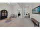 Open hallway with archways leading to other rooms and neutral-colored tile flooring at 7133 Hatpin Loop, Wesley Chapel, FL 33545
