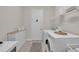 Neat and functional laundry room with washer, dryer, storage cabinets, and ample counter space at 7133 Hatpin Loop, Wesley Chapel, FL 33545