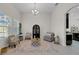 Bright living room with a decorative rug and a modern display cabinet at 7133 Hatpin Loop, Wesley Chapel, FL 33545