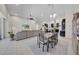 Open concept living area with dining table and large sectional sofa, filled with natural light at 7133 Hatpin Loop, Wesley Chapel, FL 33545