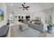 Open floor plan with living room, dining area, and kitchen with dark cabinets and island at 7133 Hatpin Loop, Wesley Chapel, FL 33545