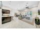 Open concept living room with a large sectional couch and modern island at 7133 Hatpin Loop, Wesley Chapel, FL 33545