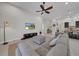 Cozy living room featuring a large sectional sofa, modern entertainment center, and stylish decor at 7133 Hatpin Loop, Wesley Chapel, FL 33545