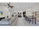 Spacious open-concept living area with dining area, seating, and kitchen, perfect for entertaining at 7133 Hatpin Loop, Wesley Chapel, FL 33545