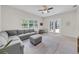 Inviting living room with comfortable seating, bright light, and seamless indoor-outdoor flow at 7133 Hatpin Loop, Wesley Chapel, FL 33545