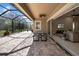 Spacious screened patio perfect for outdoor dining and relaxation. It features a table and chairs at 7133 Hatpin Loop, Wesley Chapel, FL 33545