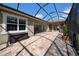 Spacious screened-in patio with brick flooring and plenty of room for outdoor entertaining at 7133 Hatpin Loop, Wesley Chapel, FL 33545