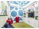 Bright playroom featuring built-in shelving, decorative wall accents, and whimsical lighting fixture at 7133 Hatpin Loop, Wesley Chapel, FL 33545