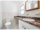 Bathroom showcases the sink vanity with storage cabinet, neutral tiling and granite countertop at 7183 Fireside St, Spring Hill, FL 34606