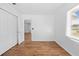 Sunny bedroom features wood floors, closet, and abundant natural light at 7183 Fireside St, Spring Hill, FL 34606