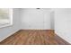 White-walled bedroom features a window, wood look flooring, and bright lighting at 7183 Fireside St, Spring Hill, FL 34606