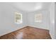 Bright bedroom featuring wood flooring and dual windows, ideal for comfort at 7183 Fireside St, Spring Hill, FL 34606