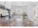 Bright kitchen features white cabinetry, sleek appliances, and speckled countertops at 7183 Fireside St, Spring Hill, FL 34606