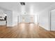 Bright living room showcasing wood-look floors, white walls, and an open layout with a view of the kitchen at 7183 Fireside St, Spring Hill, FL 34606
