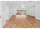 Spacious living room featuring wood-look floors and sliding glass doors that lead to a screened in patio at 7183 Fireside St, Spring Hill, FL 34606
