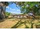 A spacious backyard featuring lush greenery, shade trees and fenced perimeter at 801 Chess Pl, Seffner, FL 33584