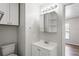 Bathroom with vanity, sink, mirror, shelves, and a separate toilet area at 801 Chess Pl, Seffner, FL 33584