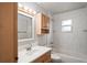 Bathroom featuring a vanity, sink, and shower-tub combination with tiled walls at 801 Chess Pl, Seffner, FL 33584