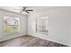 Bedroom featuring wood-look floors, a ceiling fan, and two windows for natural light at 801 Chess Pl, Seffner, FL 33584