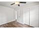 Bedroom with wood-look floors, a ceiling fan, and closet at 801 Chess Pl, Seffner, FL 33584