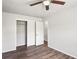 Bedroom featuring wood-look floors, a ceiling fan, closet and an adjacent room at 801 Chess Pl, Seffner, FL 33584