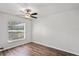 Bedroom featuring wood-look floors, a ceiling fan, and window for natural light at 801 Chess Pl, Seffner, FL 33584