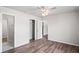 This bedroom boasts wood-look floors, a ceiling fan, and a closet for storage at 801 Chess Pl, Seffner, FL 33584