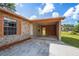 Exterior view of the home's carport featuring a stone facade and a view of the backyard at 801 Chess Pl, Seffner, FL 33584