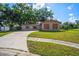 Charming single-story home with stone accents, mature trees, and a curved driveway on a sunny day at 801 Chess Pl, Seffner, FL 33584