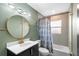 Updated bathroom featuring modern fixtures and a striking geometric patterned wall at 810 22Nd N St, St Petersburg, FL 33713